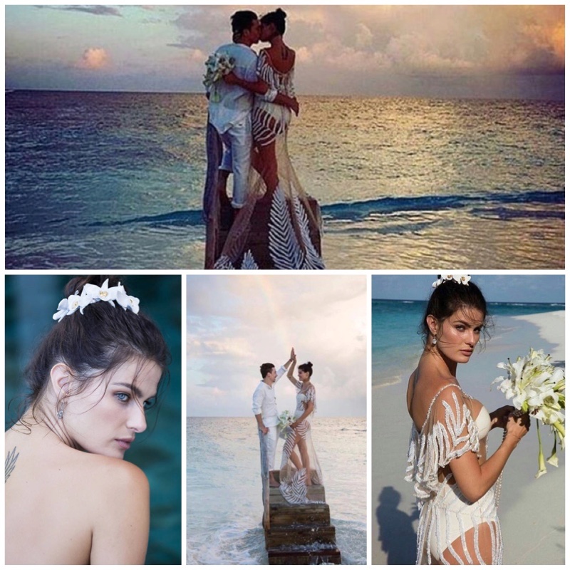 Isabeli Fontana poses at the beach wearing her sheer wedding dress and holding a white bouquet