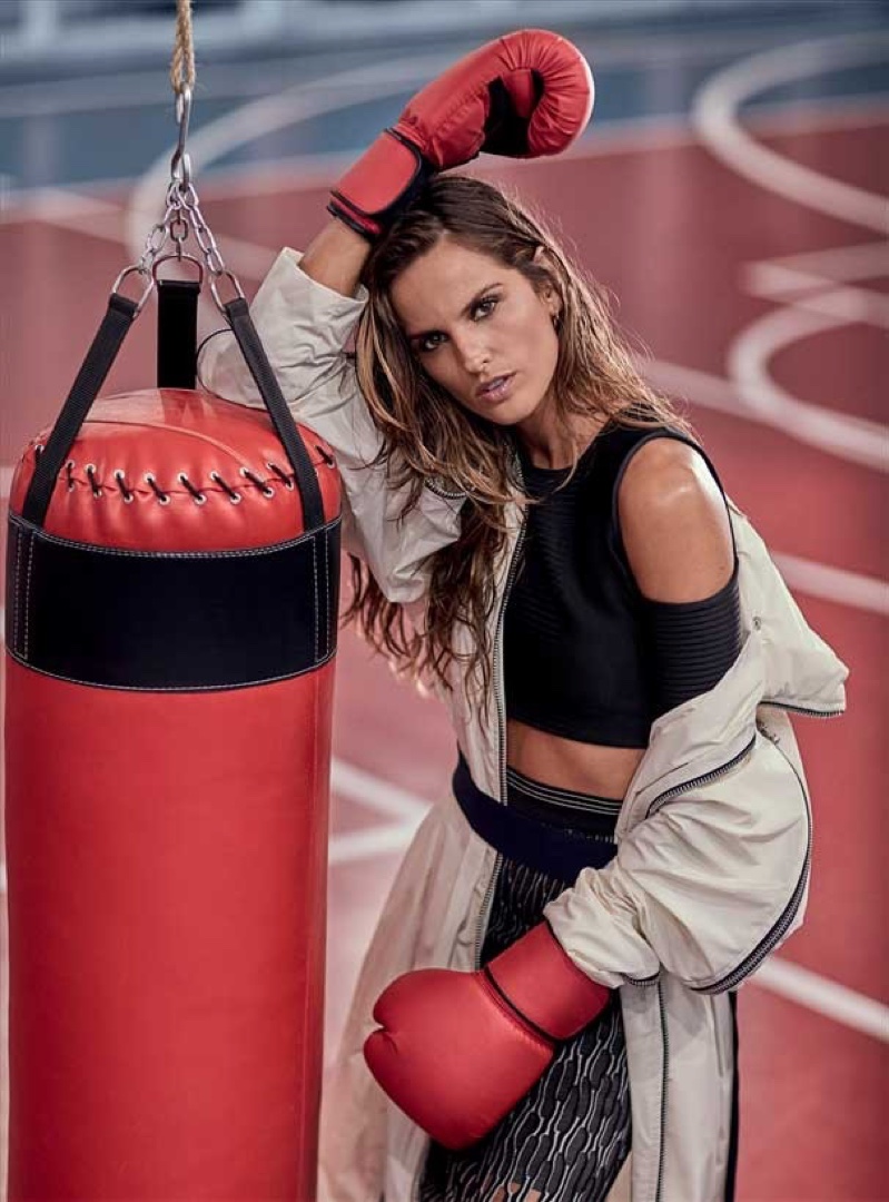 Izabel Goulart rocks some boxing gloves with crop top and high-waisted skirt