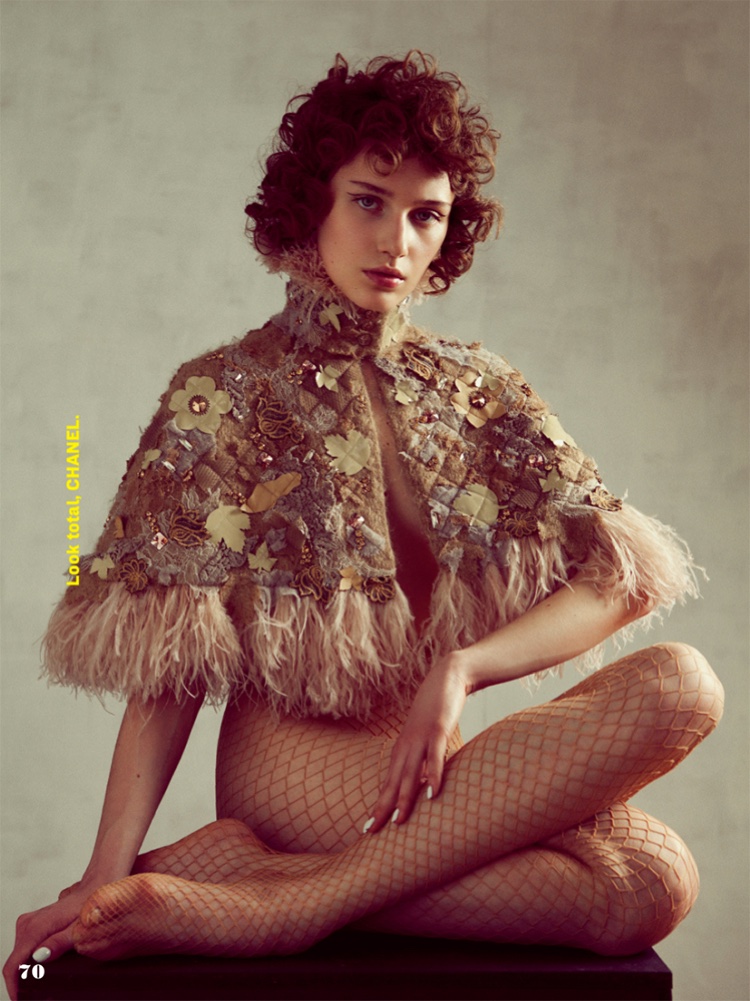 Sofia Tesmenitskaya poses in Chanel embroidered capelet and fishnet stockings