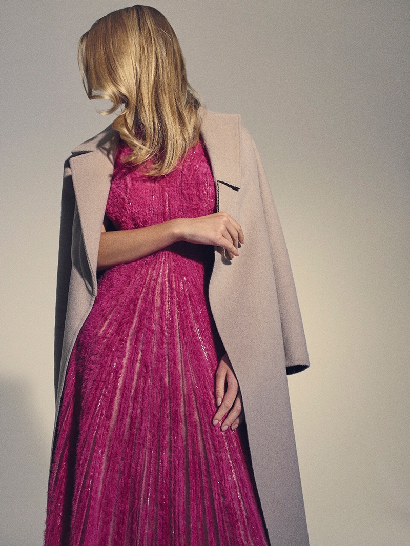 Anna Ewers poses in BOSS coat and pink dress