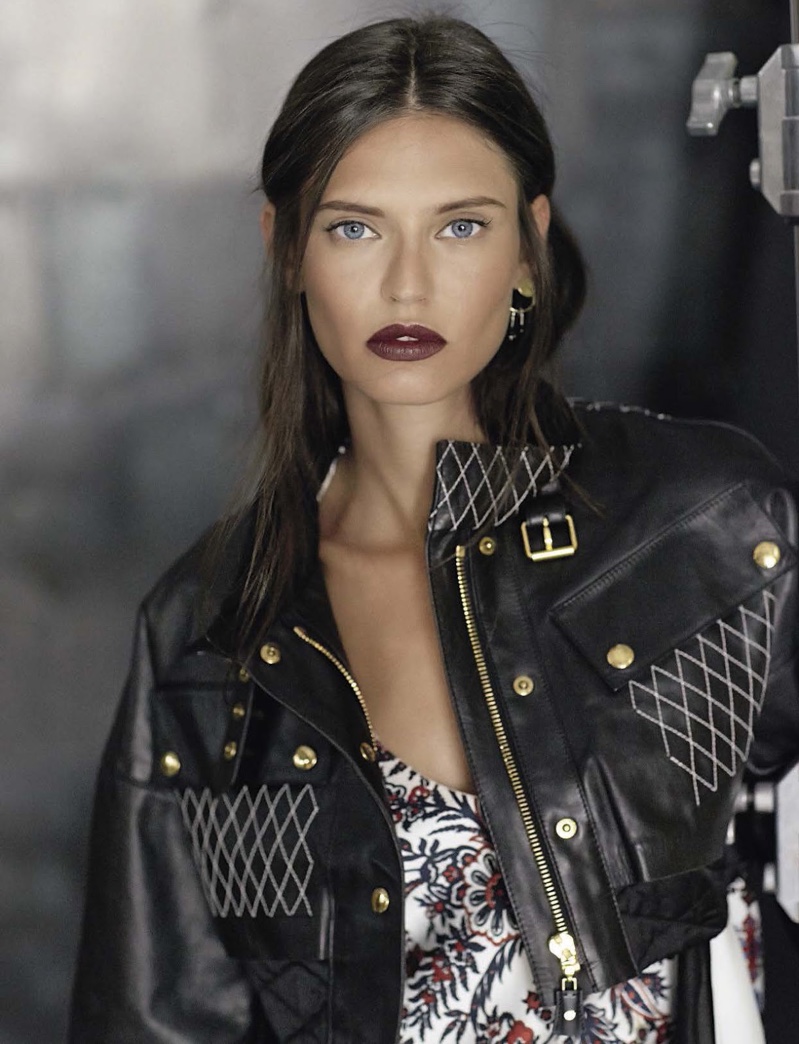 The model wears Louis Vuitton embellished leather jacket and printed dress