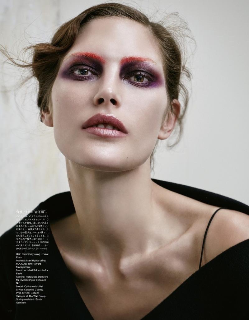 Catherine McNeil wears purple eyeshadow with eyebrows painted red and Dior top