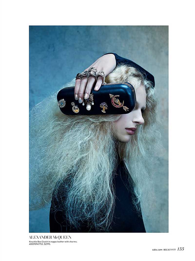 The model poses with an Alexander McQueen knuckle box clutch