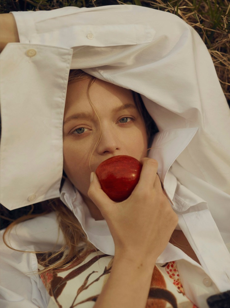 Taking a bite from an apple, Gemma Ward wears Prada shirting