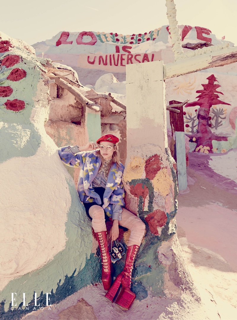 Laura Schellenberg poses in Salvation Mountain wearing a Michael Kors Collection jacket, shirt and skirt with Marc Jacobs platform boots