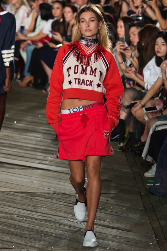 Tommy Hilfiger Fall 2016: Hailey Baldwin walks the runway in cropped sweatshirt, slouchy shorts and slip-on sneakers
