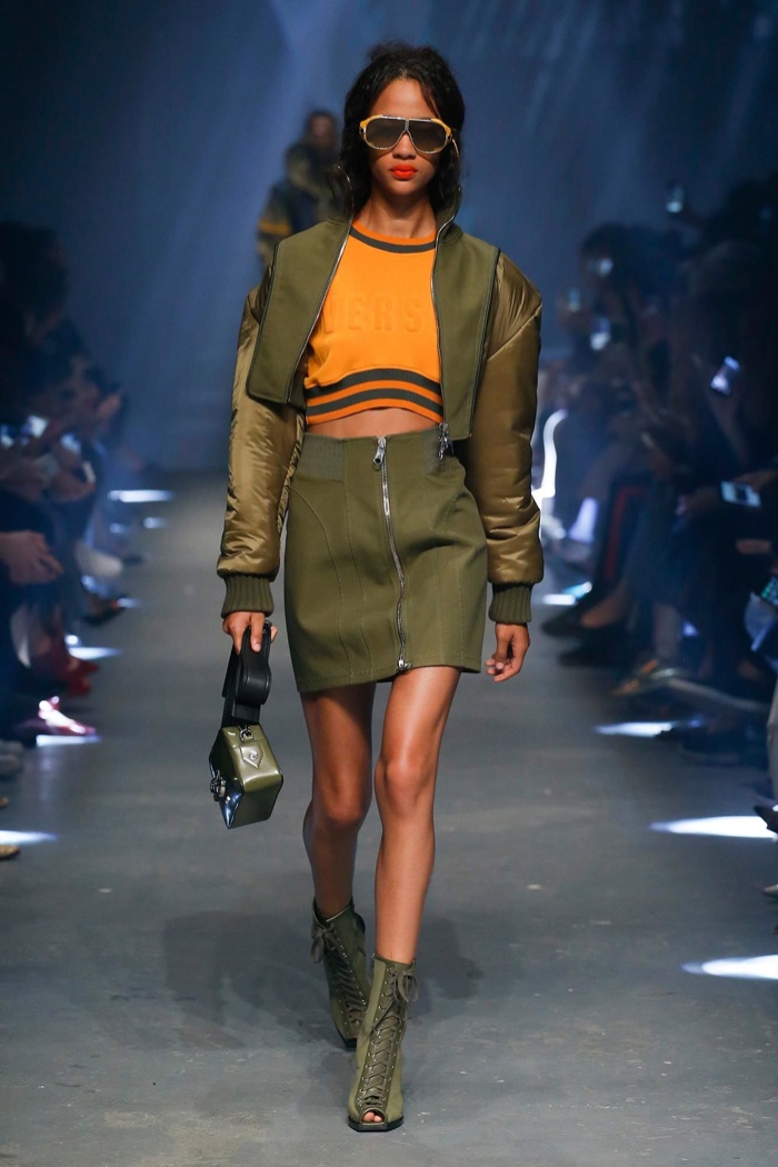 Versus Versace Spring 2017: Model walks the runway in cropped bomber jacket, branded crop top and miniskirt with zipper detail