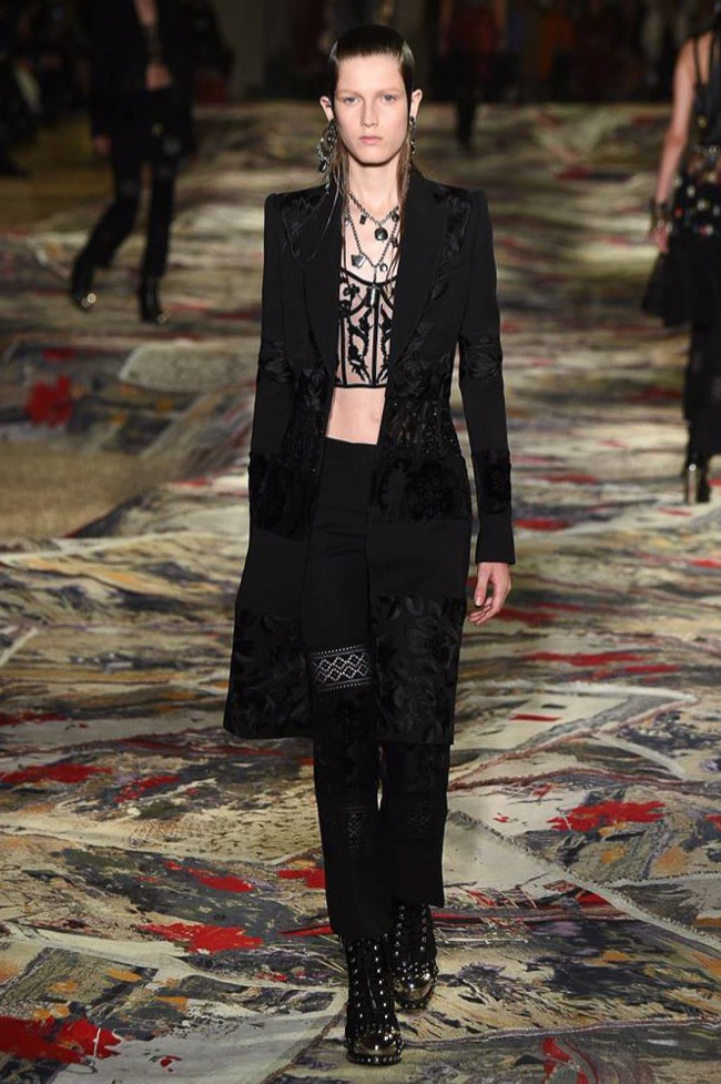 Alexander McQueen Spring 2017: Model walks the runway in embellished coat and jacket with bustier 
