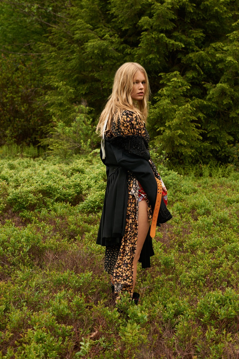 Surrounded in green, Anna Ewers poses in black blazer and kilt from DSquared2