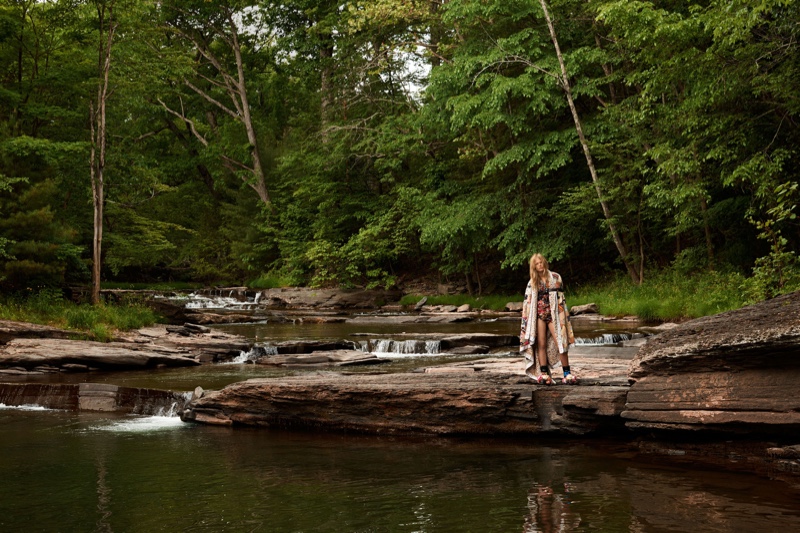 The model embraces the outdoor life in a patchwork blanket