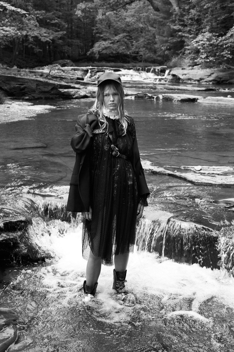 The model poses at a lake in the grunge inspired look