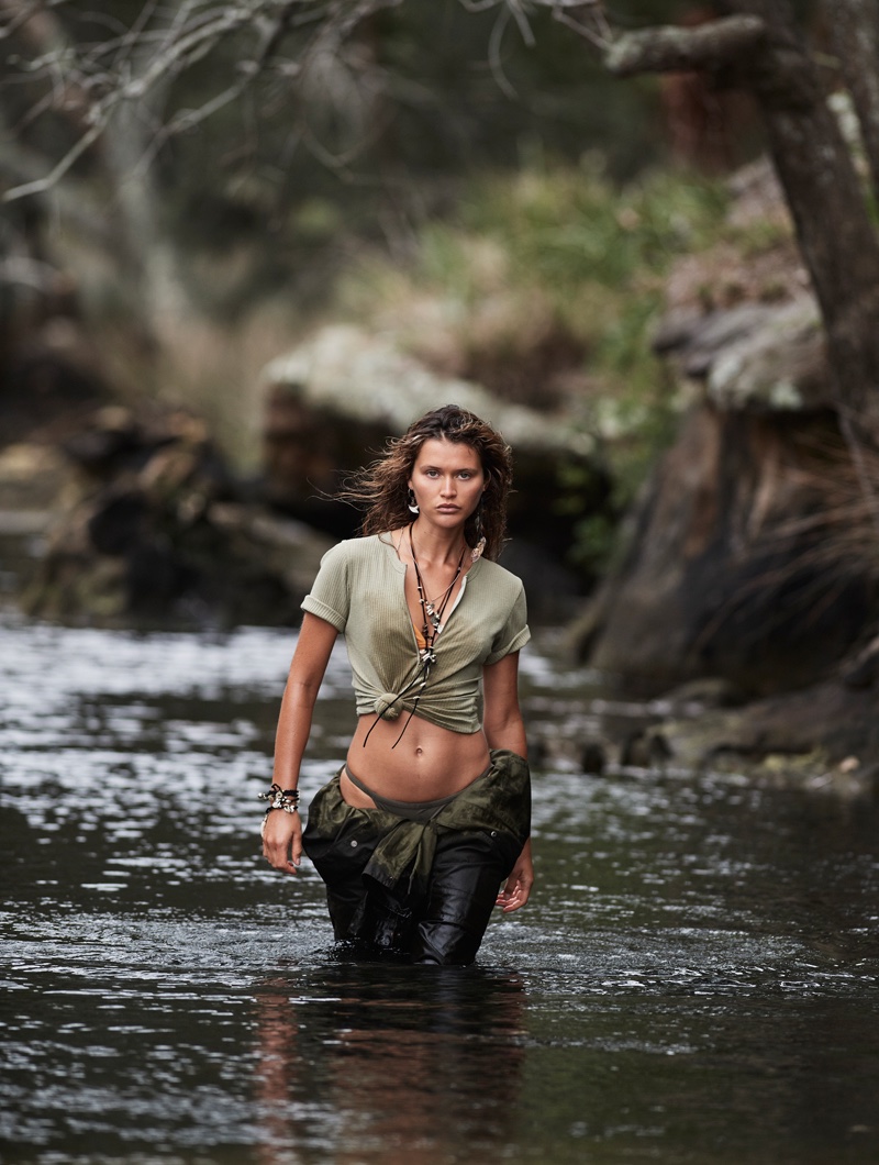 Walking through water, Chloe Lecareux poses in Ryder top over Matteau bikini top with Fella bikini briefs