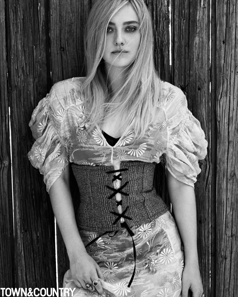 Dakota Fanning poses in Prada dress and wool corset