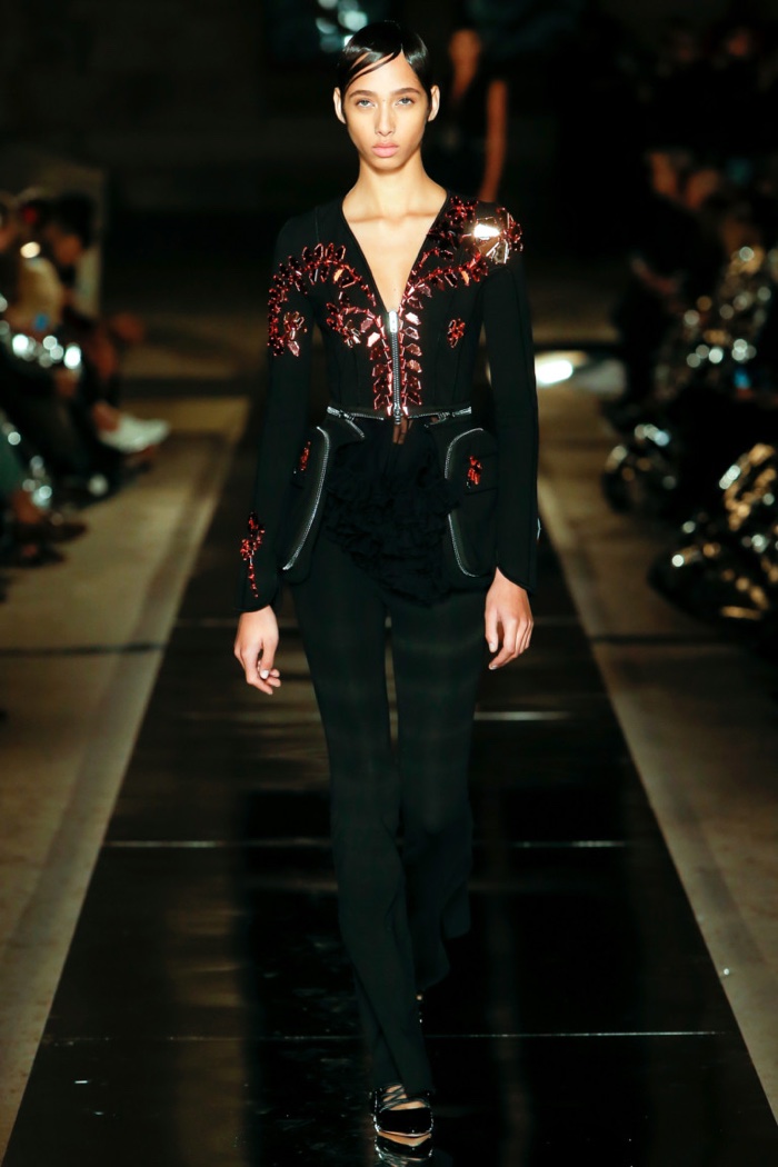 Givenchy Spring 2017: Model walks the runway in embellished jacket over black pants