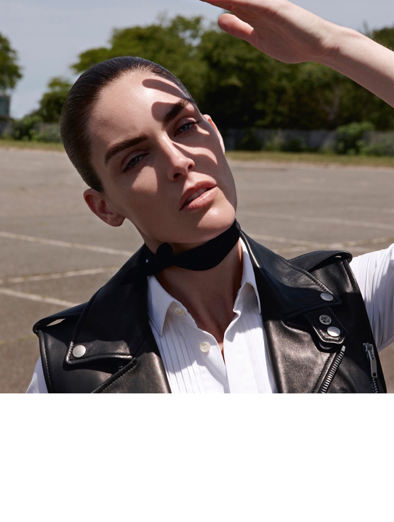 Sporting a rebellious look, Hilary Rhoda wears a Saint Laurent leather vest and shirt with Chloe scarf