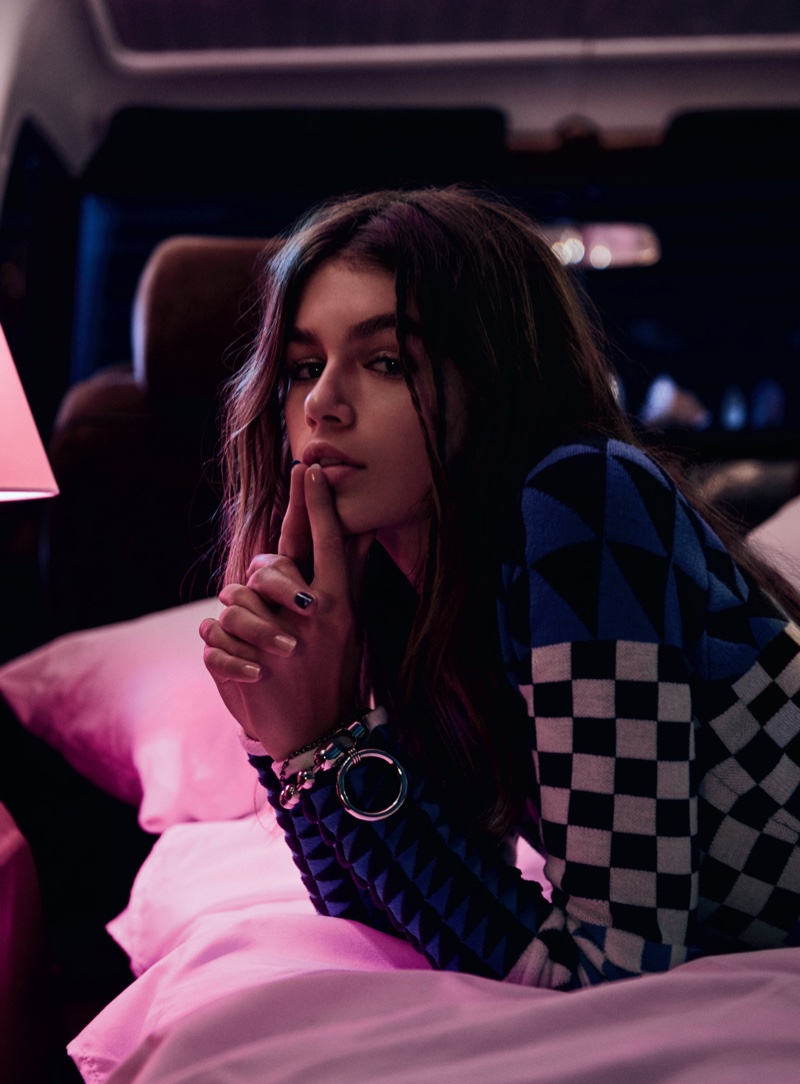 Model Kaia Gerber poses in checkered sweater from Altuzarra