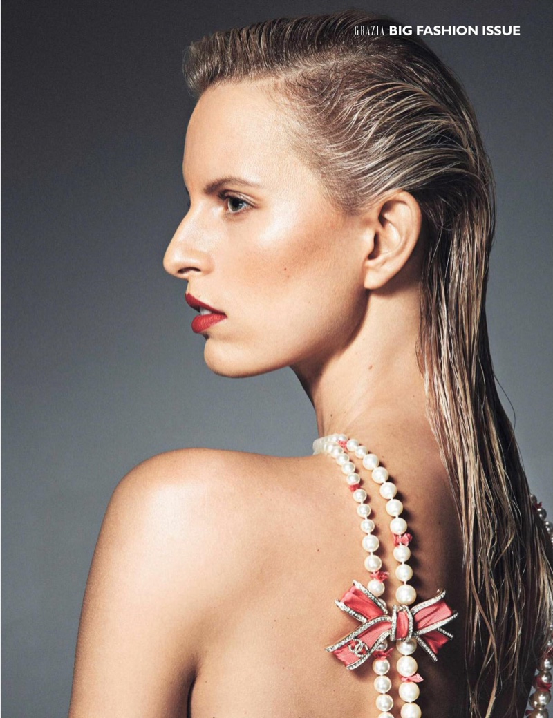 Karolina Kurkova wears slick hairstyle with Chanel pearl necklace