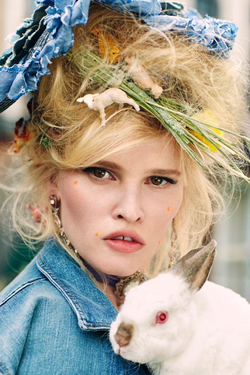 Lara Stone wears messy hairstyle while holding a rabbit