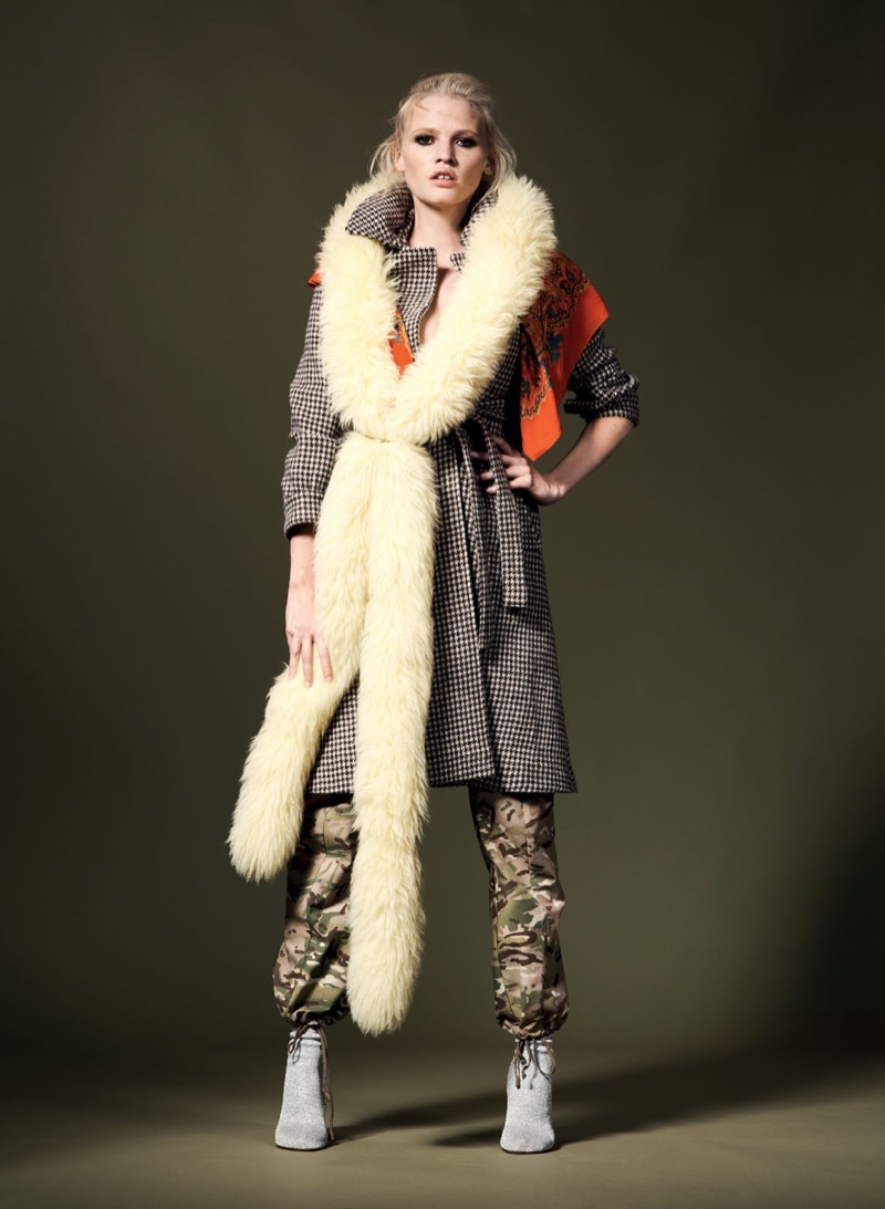 Lara Stone poses in fur stole, checkered coat and camouflage print pants