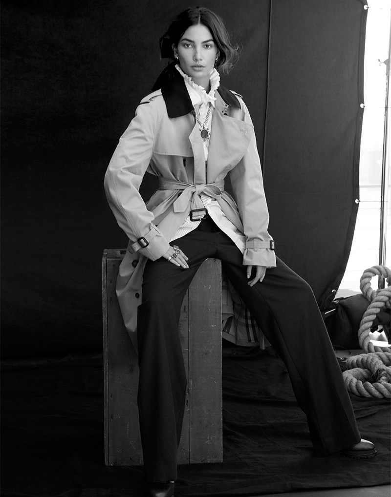 Photographed in black and white, Lily Aldridge wears Burberry trench coat, ruffled top and pants