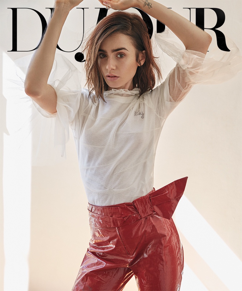 Bringing some edge to her look, Lily Collins wears Burberry ruffle collar shirt and red Isabel Marant pants
