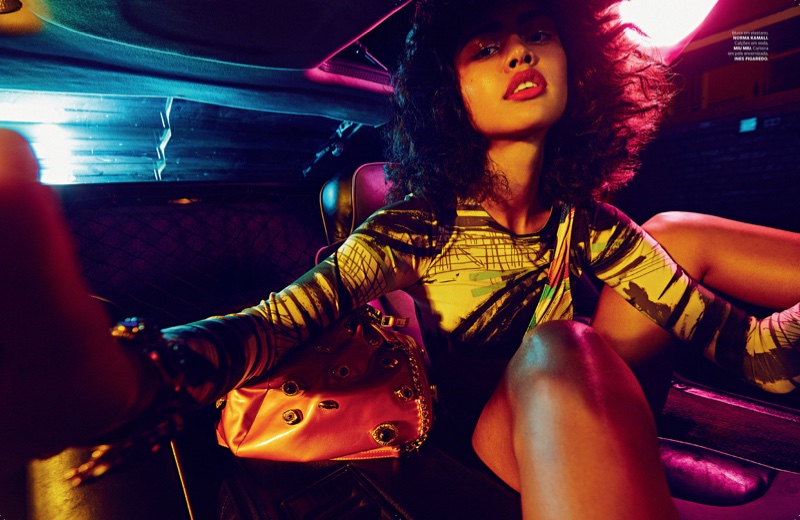 Sitting in the back of a car, Luz Pavon models Norma kamali blouse with Miu Miu handbag