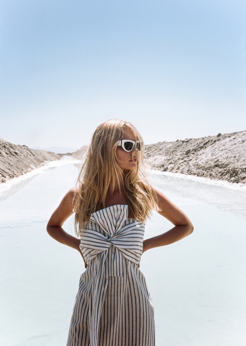 Embracing the sun, Marloes Horst wears a striped dress with bow at the front