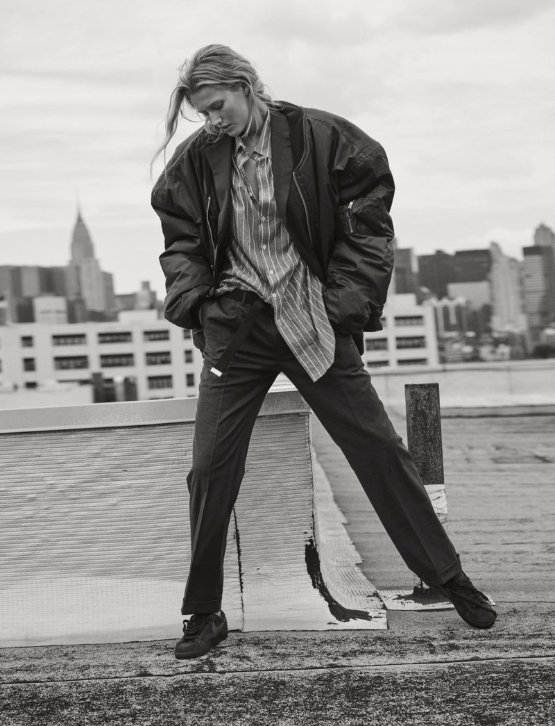 Posing outdoors, Toni Garrn models Vetements bomber jacket with Nike sneakers