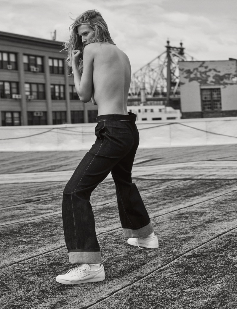 Posing topless, Toni Garrn models Emporio Armani jeans with Reebok sneaker