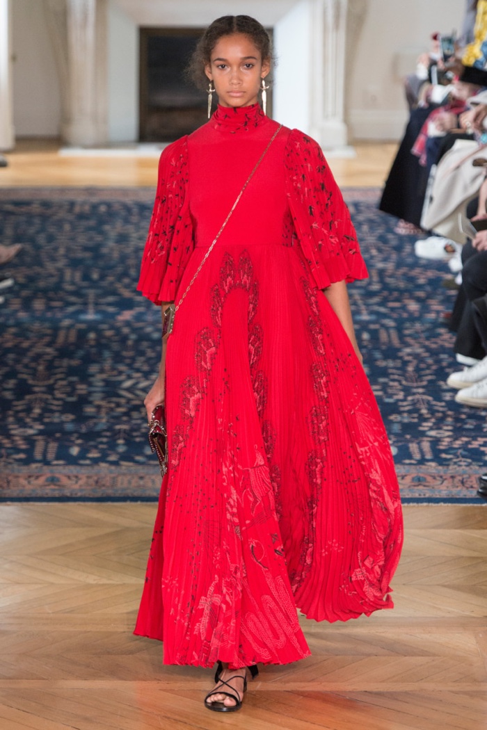 Valentino Spring 2017: Model walks the runway in red gown with pleated sleeves and skirt