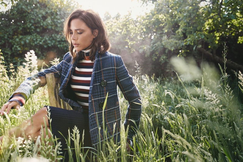 Victoria Beckham poses in Victoria Beckham coat, sweater and skirt