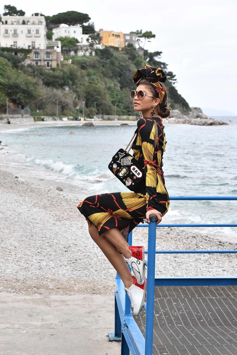 Wearing a pasta print dress, Zendaya Coleman poses behind-the-scenes at Dolce & Gabbana's spring 2017 campaign