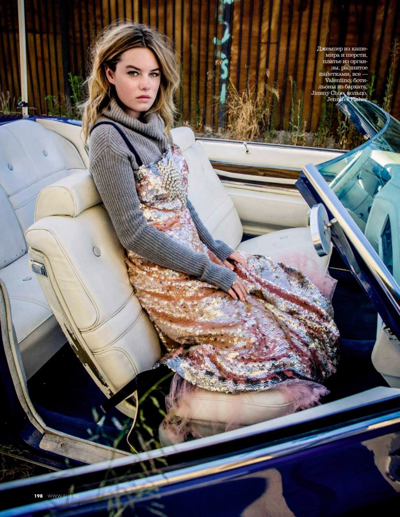 Model Camille Rowe layers up in Valentino sweater and sequin dress with Jimmy Choo boots