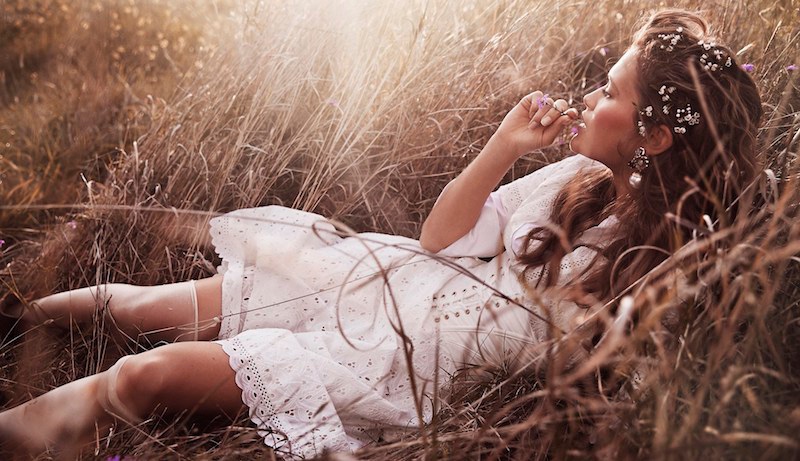 Lounging in a field, Chloe Lecareux models white lace