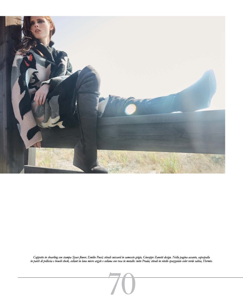 Sitting on a fence, Coco Rocha models Emilio Pucci shearling cape with Giuseppe Zanotti Design boots