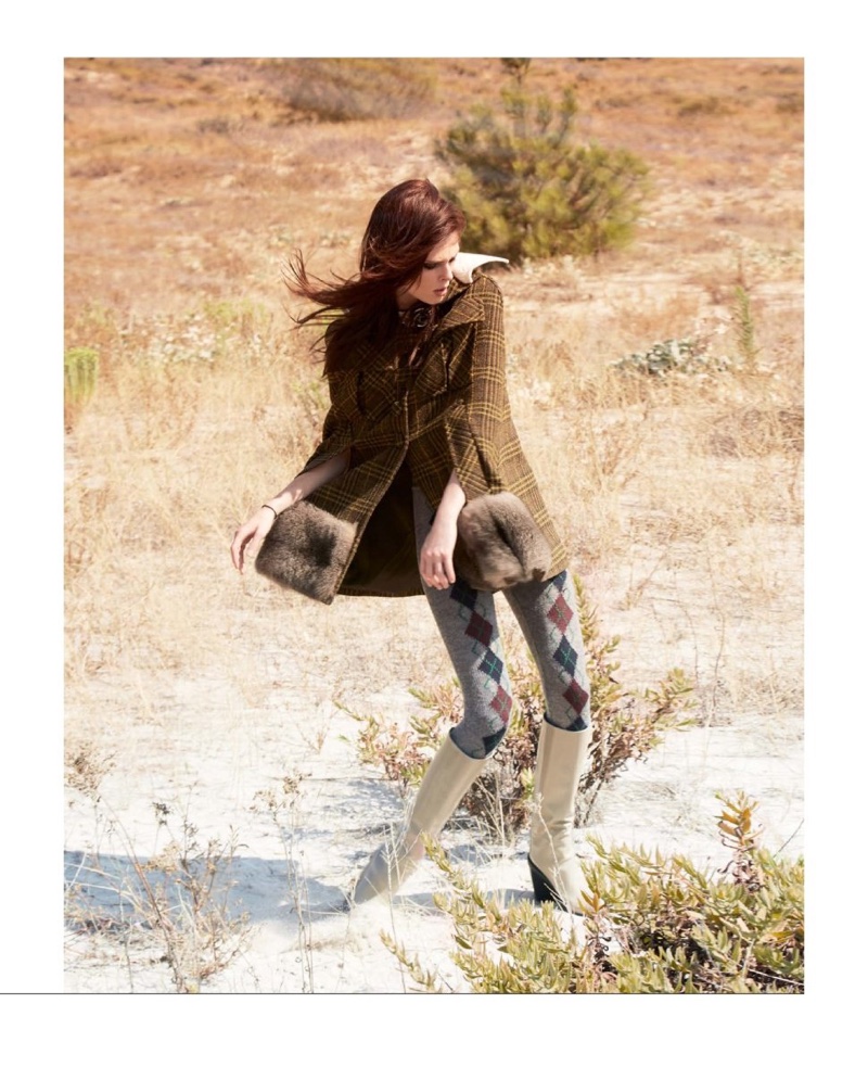 Striking a pose, Coco Rocha models a Prada jacket, wool tights and Hermes boots