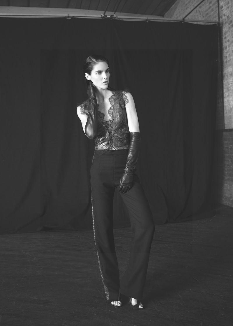 Model Hilary Rhoda wears lace top and high-waist trousers