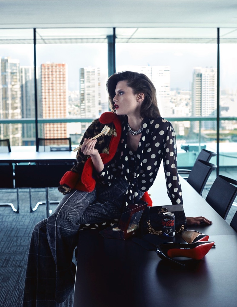 Posing in a boardroom, Elena Melnik models Gucci jacket, polka dot blouse and Calvin Klein Collection pants