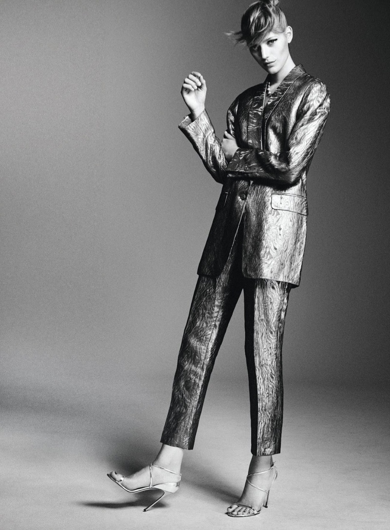 Photographed in black and white, Esther Heesch wears metallic jacket and pants