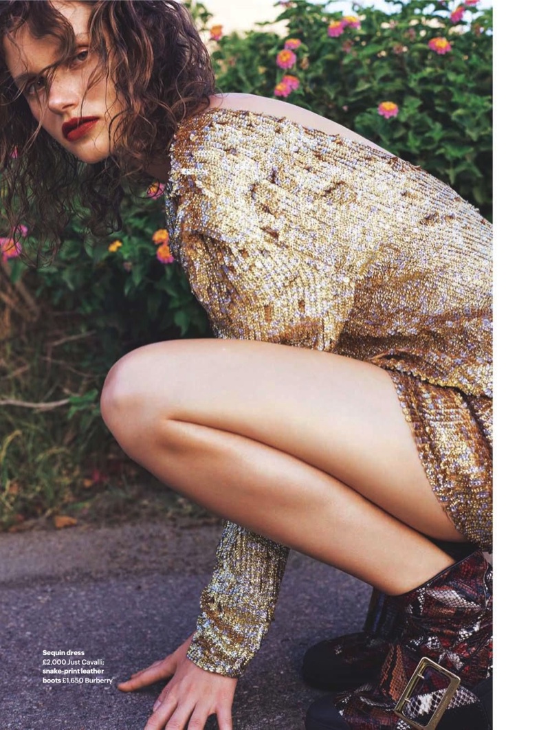 Shining in gold, Giedre Dukauskaite poses in Just Cavalli sequin dress with Burberry snake-print leather boots