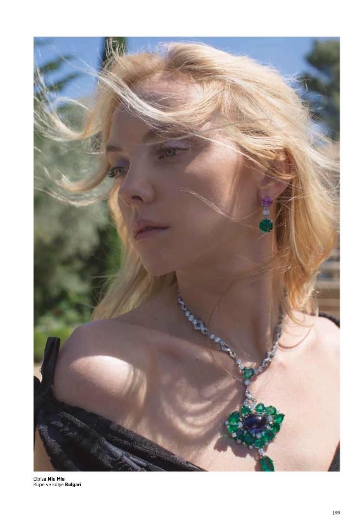 The model gets her closeup in Miu Miu off-the-shoulder dress and Bulgari jewelry