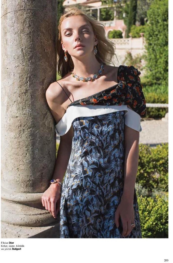 The blonde model wears printed Dior dress with Bulgari jewelry