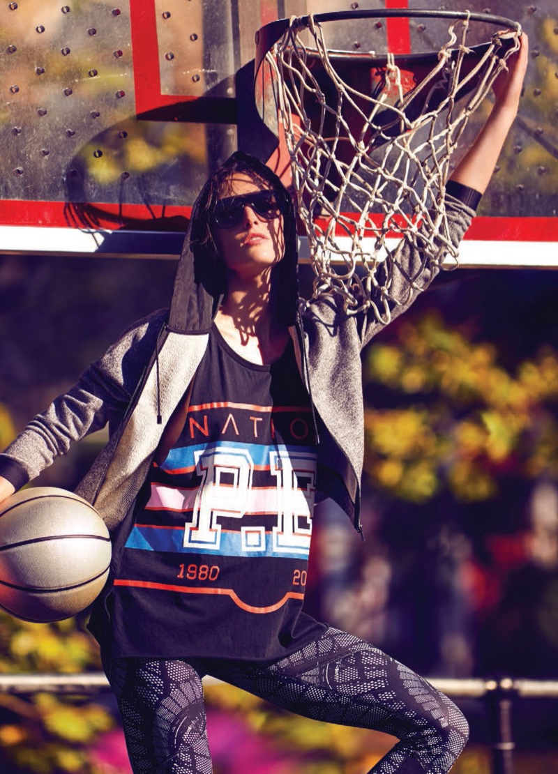 Hilary Rhoda models Armani Exchange hoodie, P.E. Nation tank, Champion leggings and Osklen sunglasses