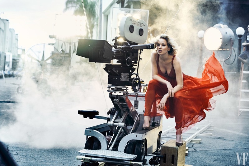 Posing behind a camera, Jennifer Lawrence wears a Dior dress and heels