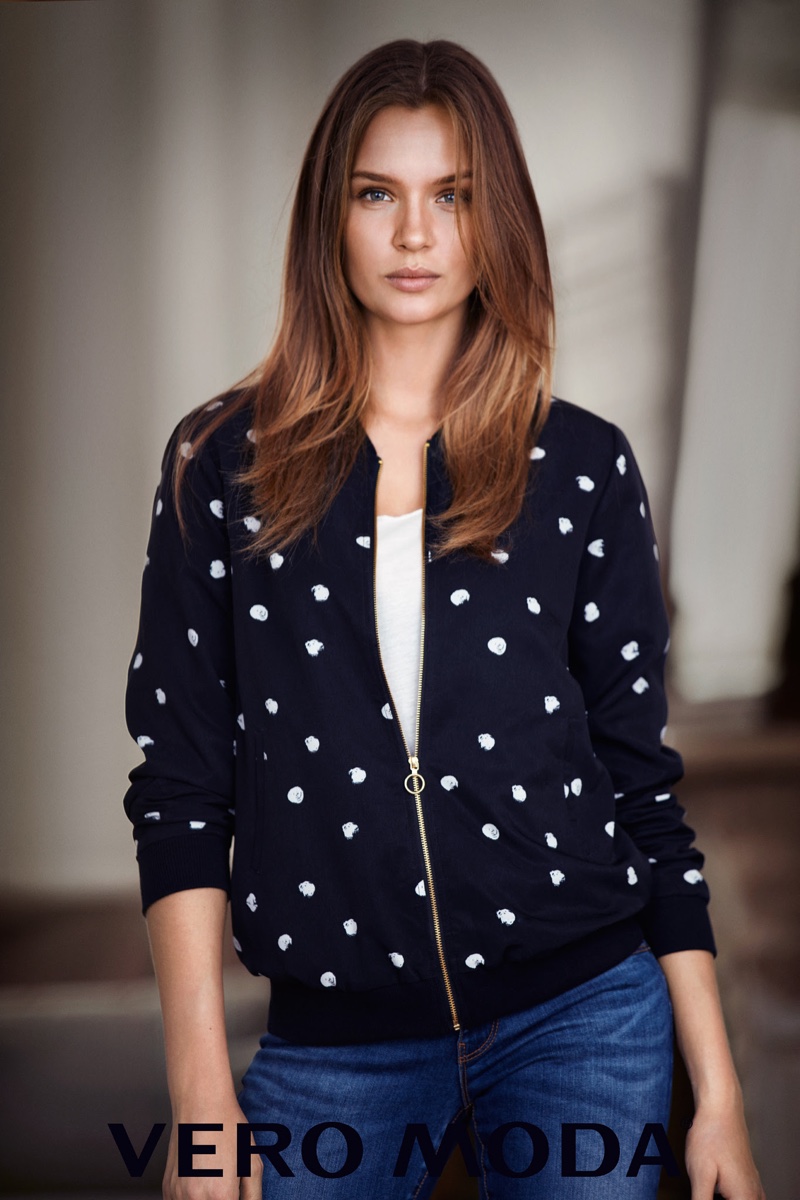 Model Josephine Skriver wears zip-up jacket with blue jeans