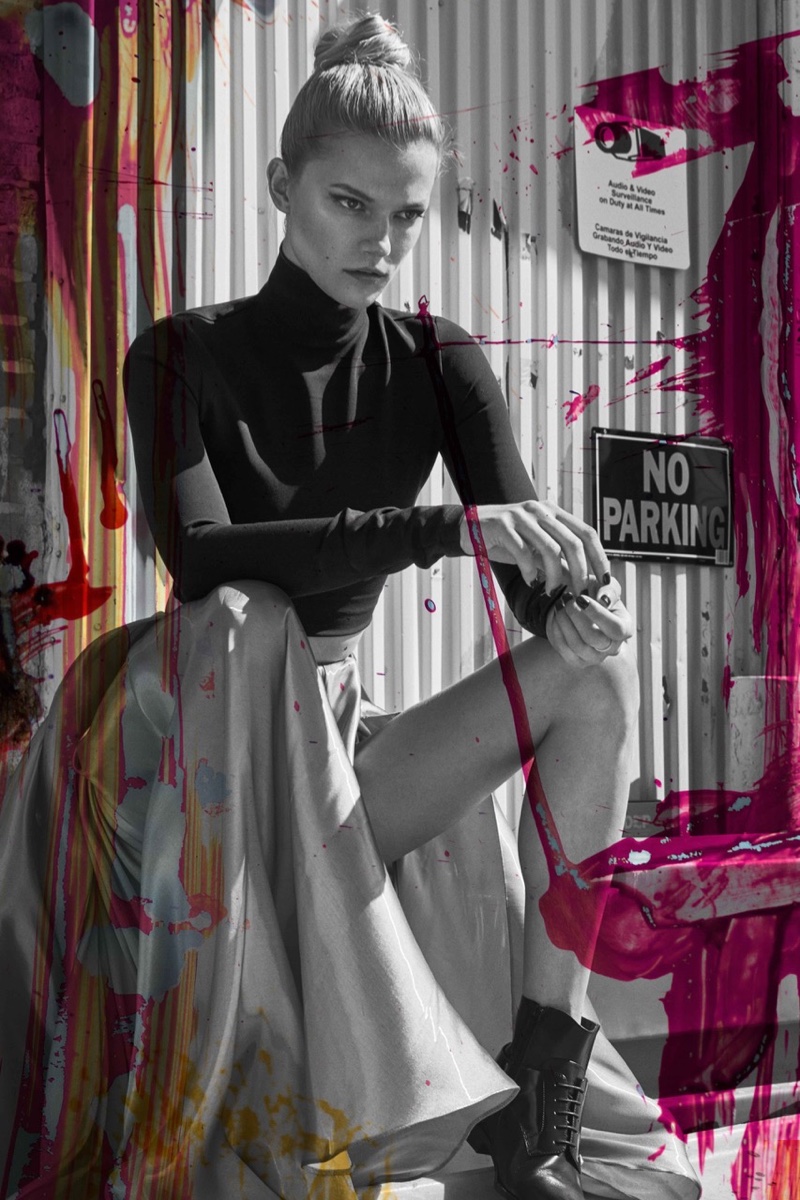 Taking a seat, Kasia Struss models Ralph Lauren Collection turtleneck and skirt with Versus Versace boots