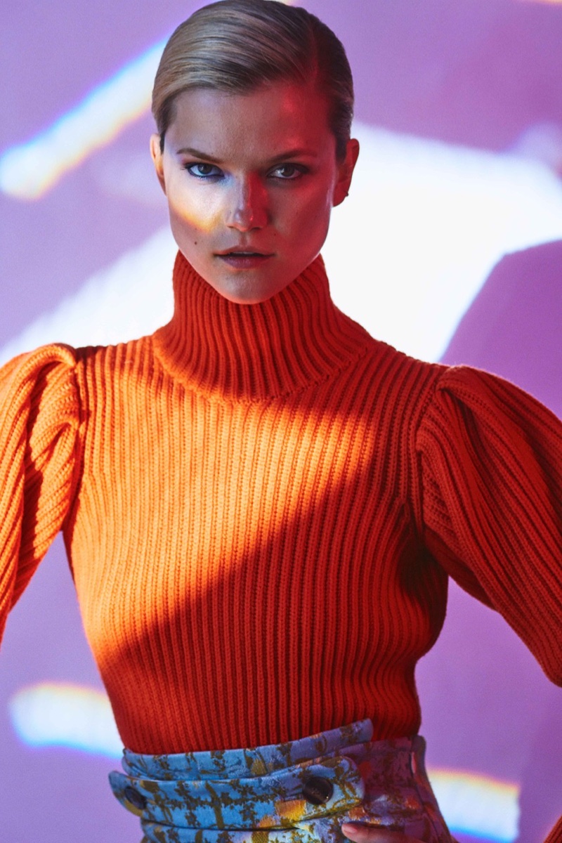 Model Kasia Struss wears cashmere turtleneck sweater from Dior