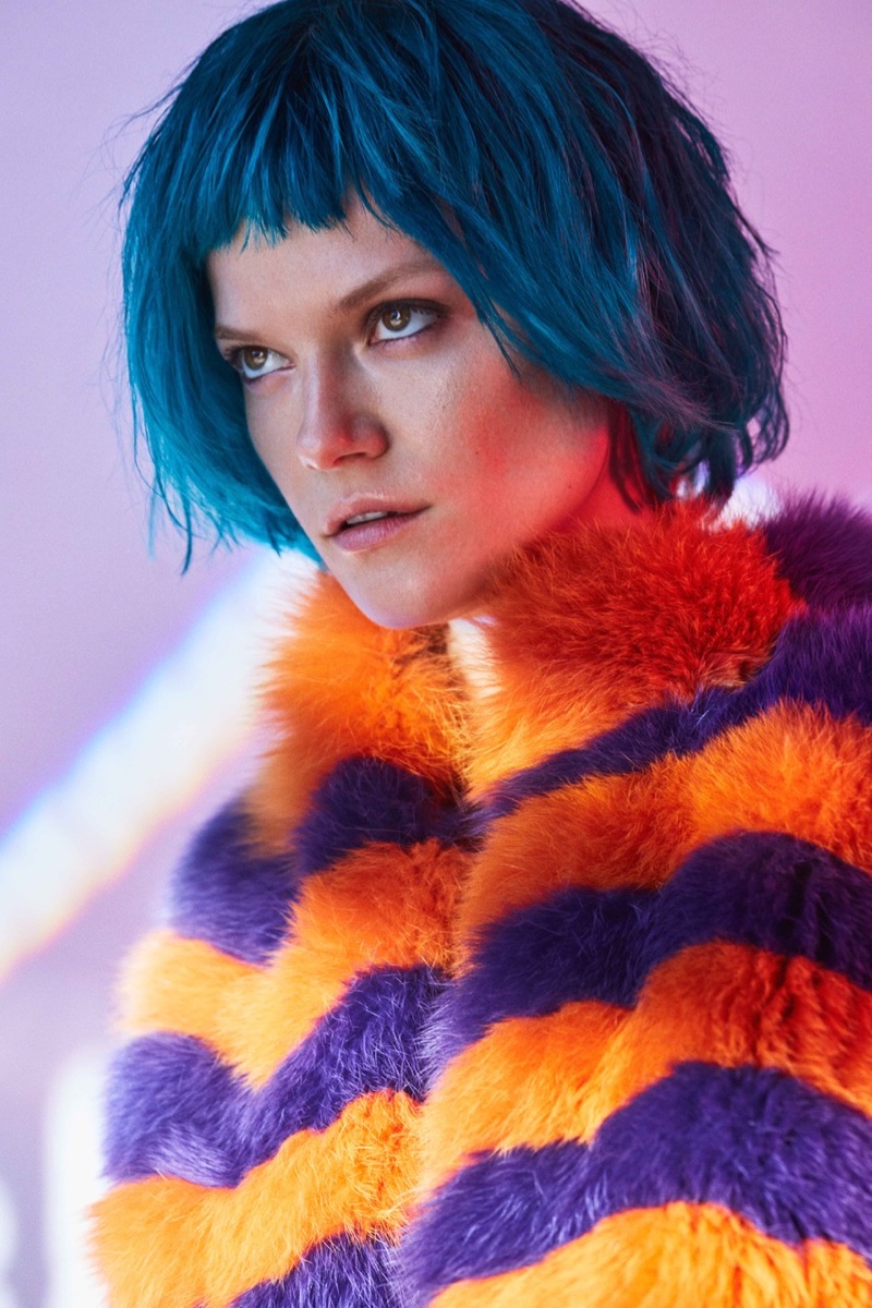 Wearing a blue cropped hairstyle, Kasia Struss poses in Fendi multicolor vest