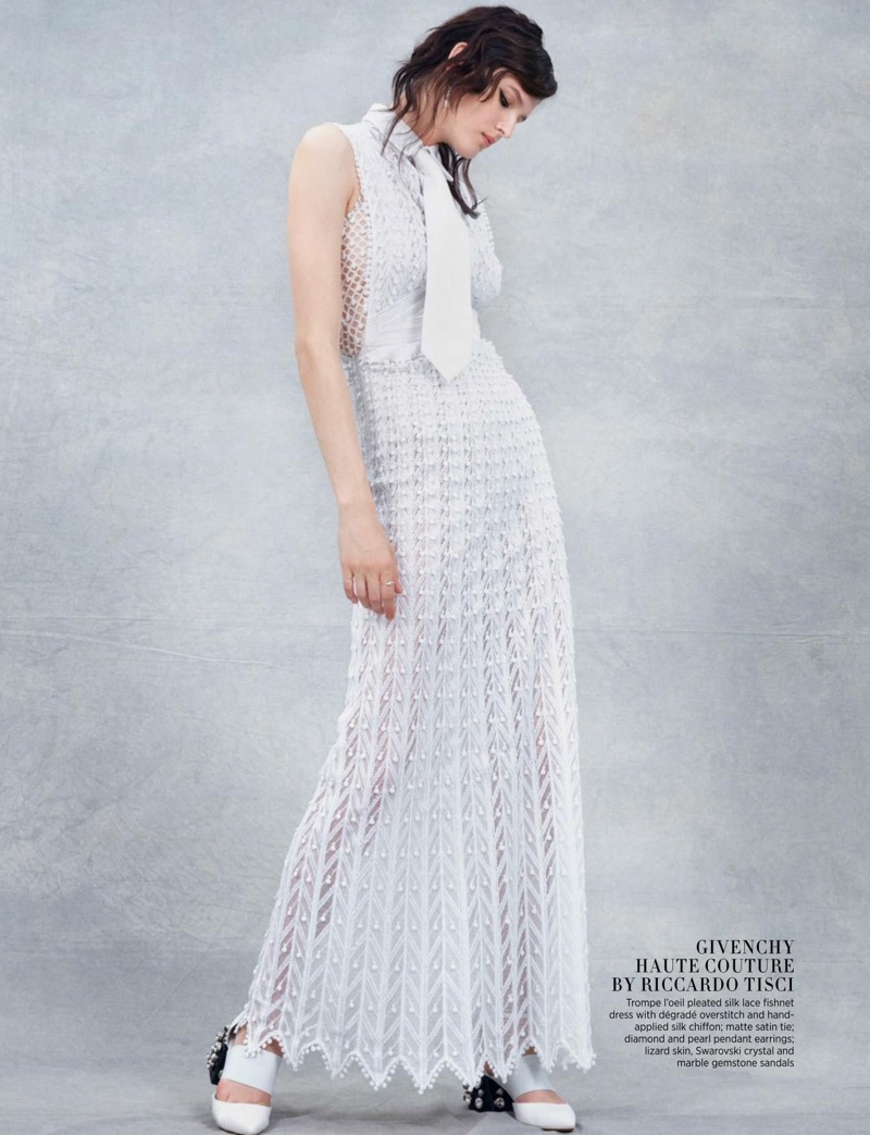 Looking elegant in white, the model poses in pleated silk lace dress from Givenchy Haute Couture