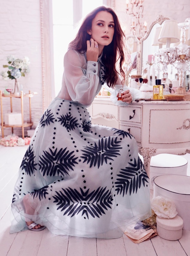 Taking a seat, Keira Knightley poses in Chanel dress